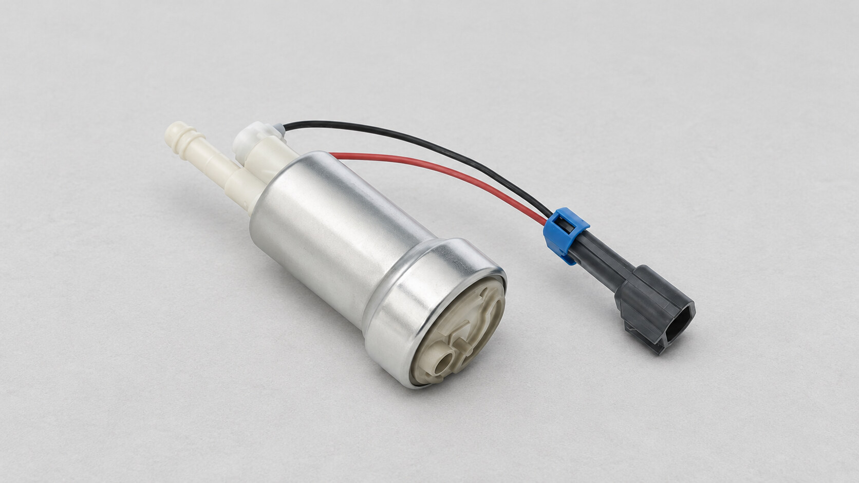 Walbro F90000285 in-tank fuel pump with wiring pigtail on a neutral grey surface.
